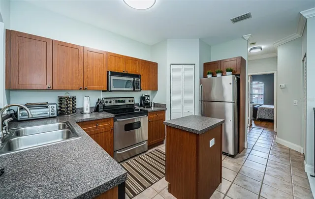 a kitchen with stainless steel appliances granite countertop a refrigerator stove and sink
