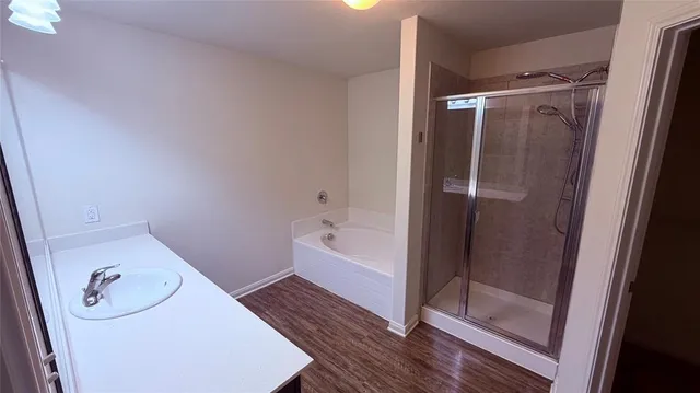 a bathroom with a bathtub and a shower