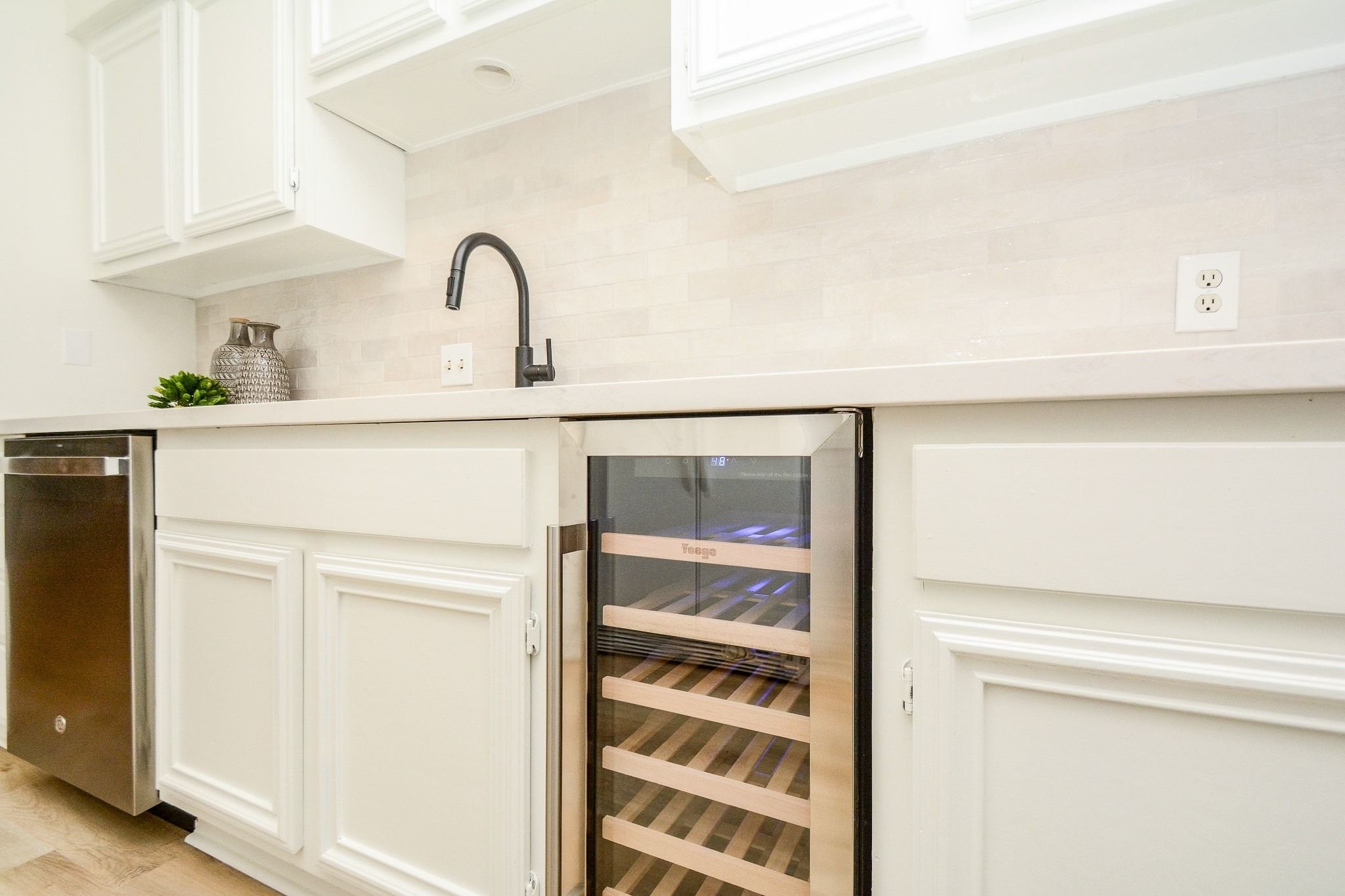 820 Harold Street Houston, TX 77006 - Photo 10 of 33 The built-in wine fridge adds a fun touch right at the sink, ready for your next dinner party.
