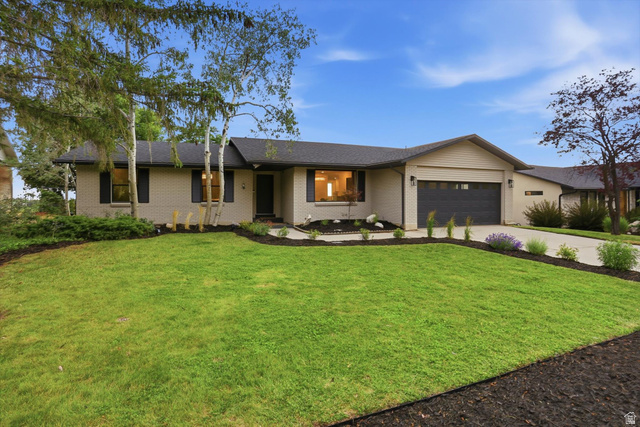 8760 Rustler Road Cottonwood Heights, UT 84093 - Photo 2 of 57 Ranch-style exterior with a gray brick facade and dark roof