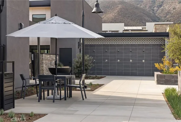 a view of a patio with a table and chairs and potted plants
