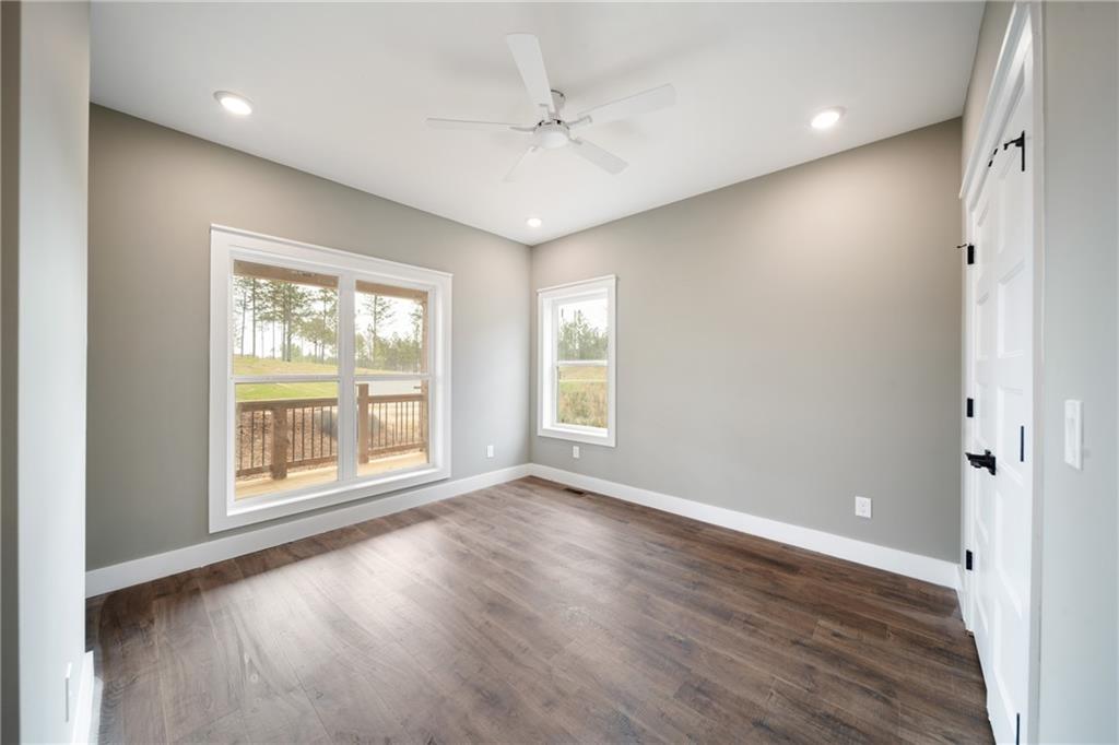 2956 Blalock Mountain Road Talking Rock, GA 30175 - Photo 21 of 65 an empty room with wooden floor and windows