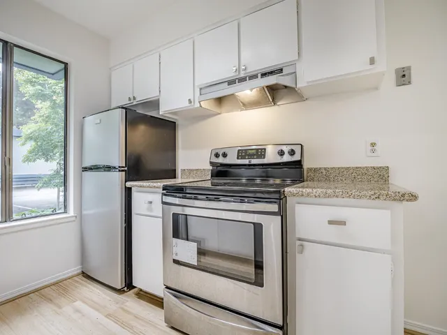 a kitchen that has a sink and a stove