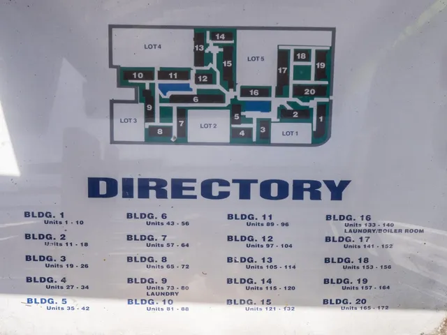 a view of a chairs and table in patio with wooden fence