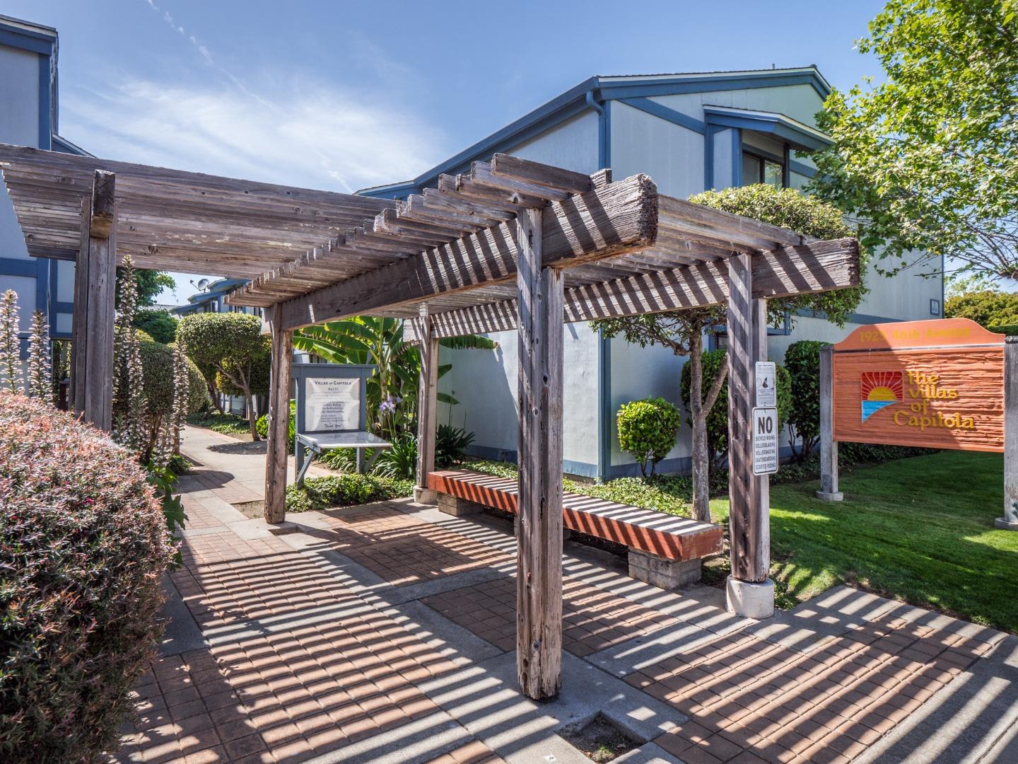1925 46th Avenue, Unit 71 Capitola, CA 95010 - Photo 27 of 36 a view of a chairs and table in patio with wooden fence