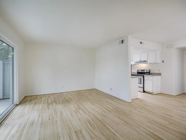 a view of kitchen with granite countertop cabinets and wooden floor