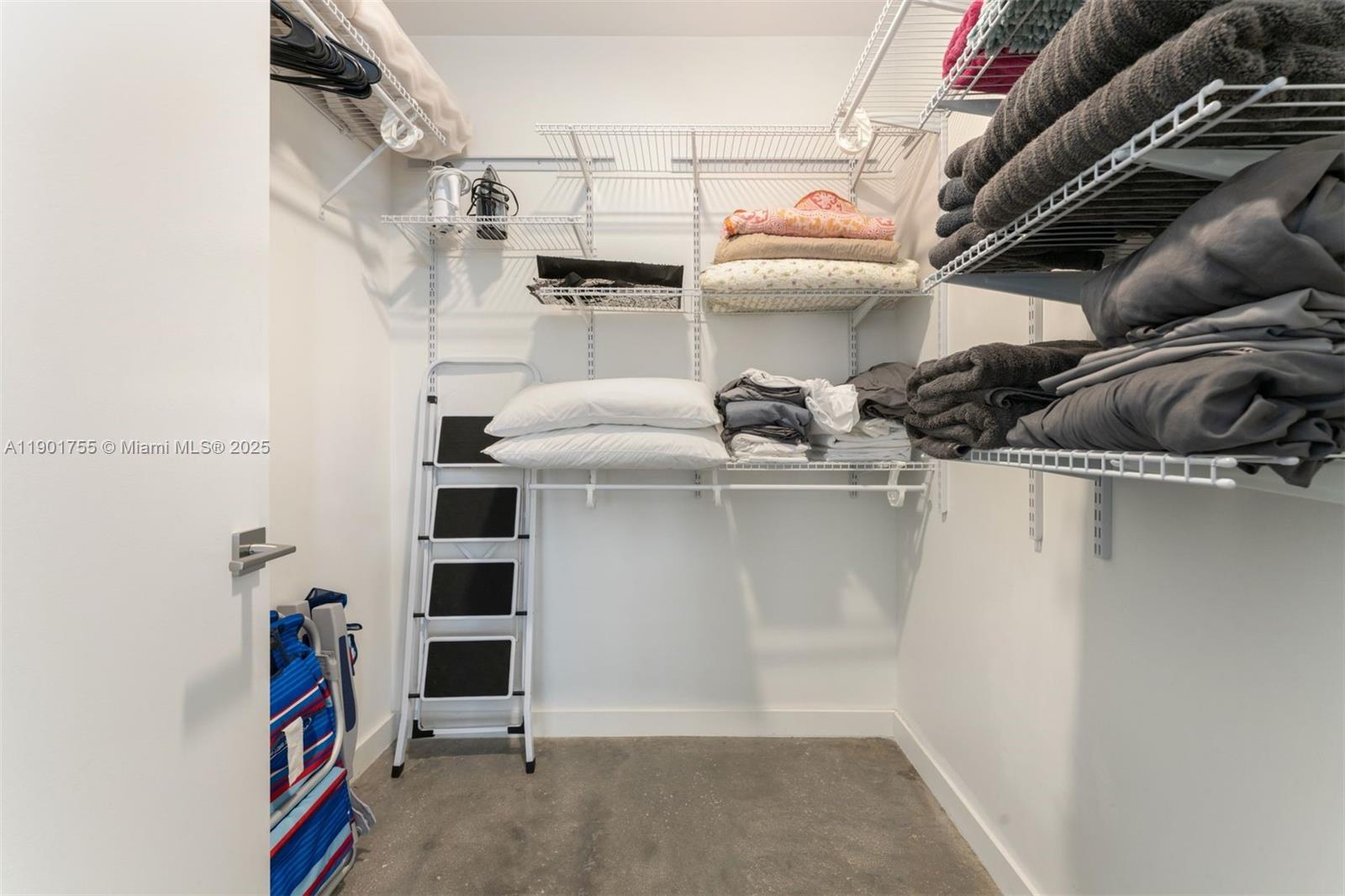 250 Northwest 24th Street, Unit 2B Miami, FL 33127 - Photo 11 of 16 a view of walk in closet with clothes and shoes