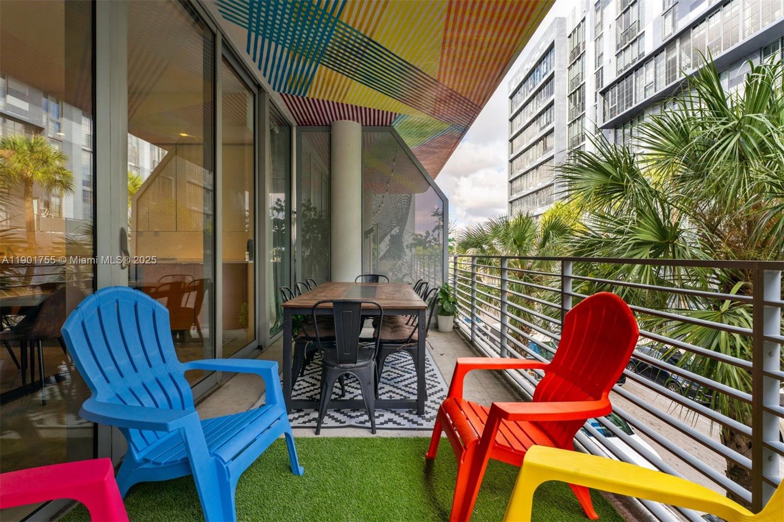 250 Northwest 24th Street, Unit 2B Miami, FL 33127 - Photo 14 of 16 a patio with patio a table and chairs and potted plants