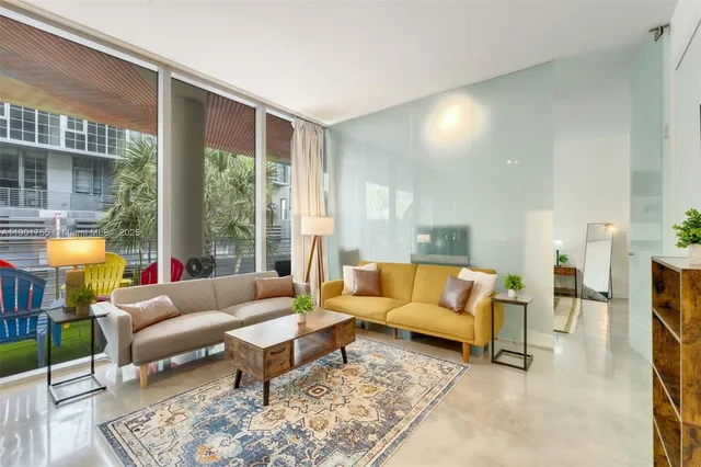 a living room with furniture and a large window