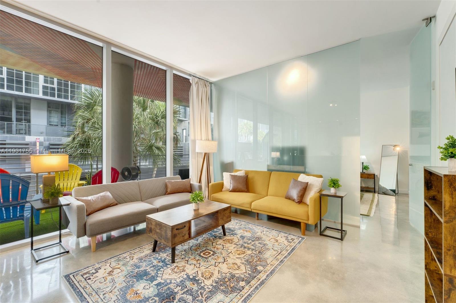 250 Northwest 24th Street, Unit 2B Miami, FL 33127 - Photo 5 of 16 a living room with furniture and a large window