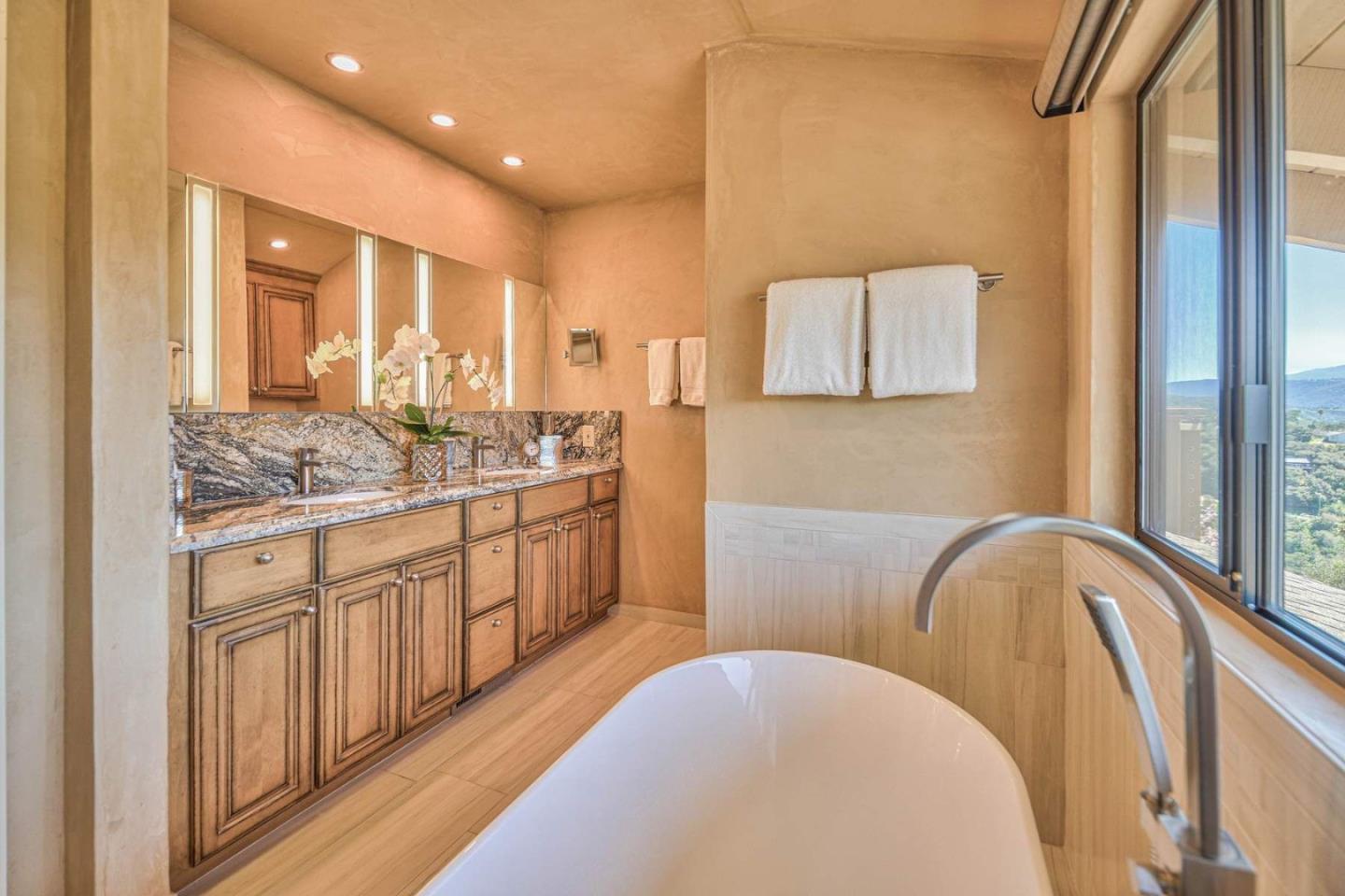 13369 Middle Canyon Road Carmel Valley, CA 93924 - Photo 22 of 45 a spacious bathroom with a tub sink and mirror