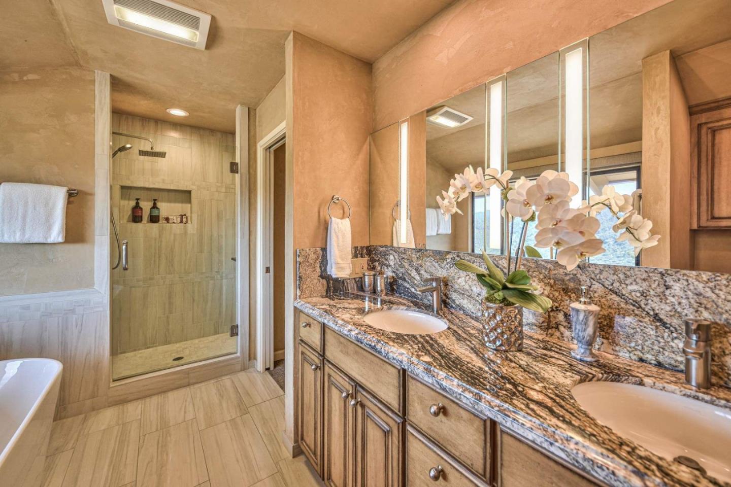 13369 Middle Canyon Road Carmel Valley, CA 93924 - Photo 23 of 45 a bathroom with double vanity sinks and a shower
