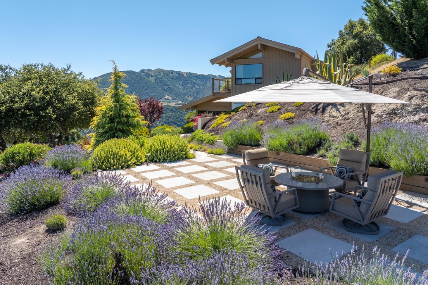 13369 Middle Canyon Road Carmel Valley, CA 93924 - Photo 34 of 45 a view of a patio with table and chairs under an umbrella