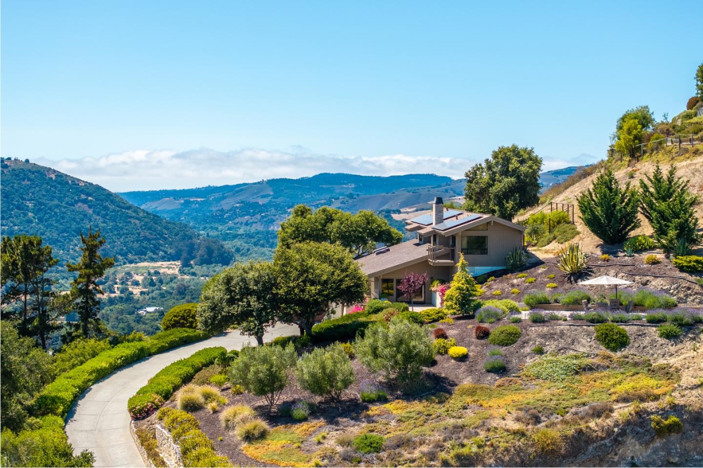 13369 Middle Canyon Road Carmel Valley, CA 93924 - Photo 36 of 45 a view of a house with a garden and mountains