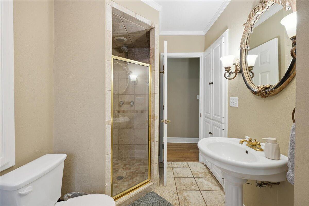 2702 20th Street Lubbock, TX 79410 - Photo 17 of 34 a bathroom with a sink toilet and shower
