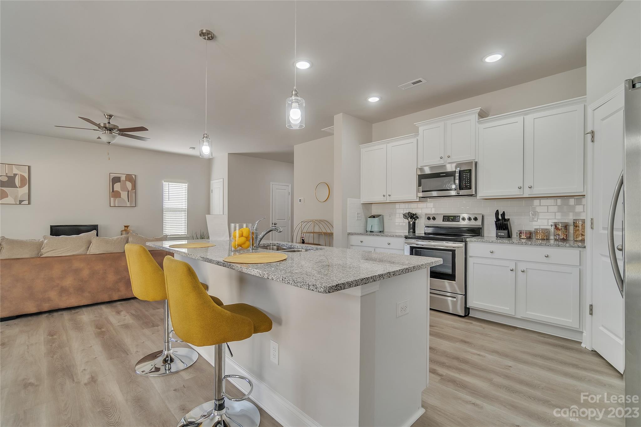 12840 Statesville Road, Unit 15B Huntersville, NC 28078 - Photo 11 of 37 a kitchen with kitchen island granite countertop a sink counter top space and appliances