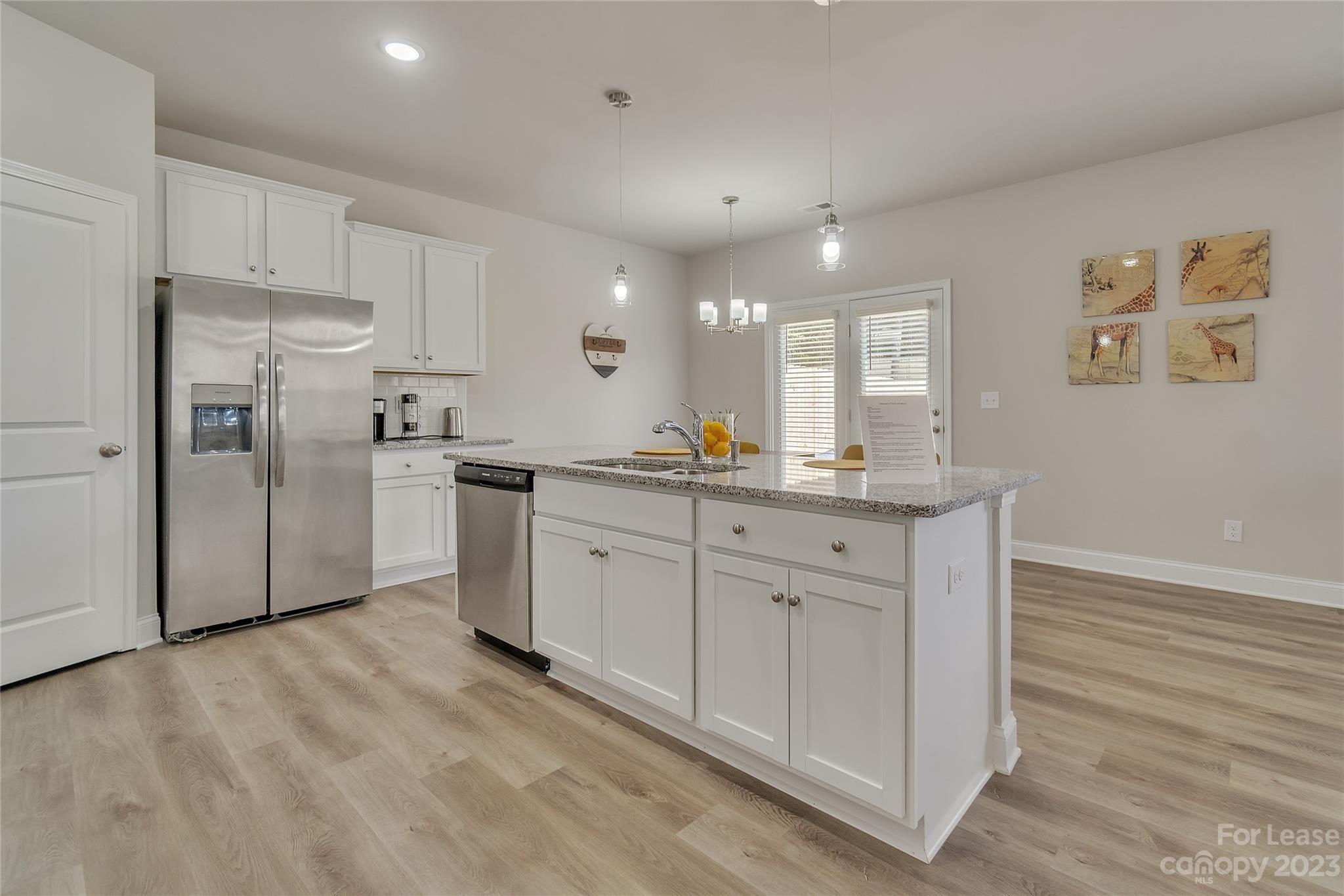 12840 Statesville Road, Unit 15B Huntersville, NC 28078 - Photo 13 of 37 a kitchen with stainless steel appliances a refrigerator sink and microwave