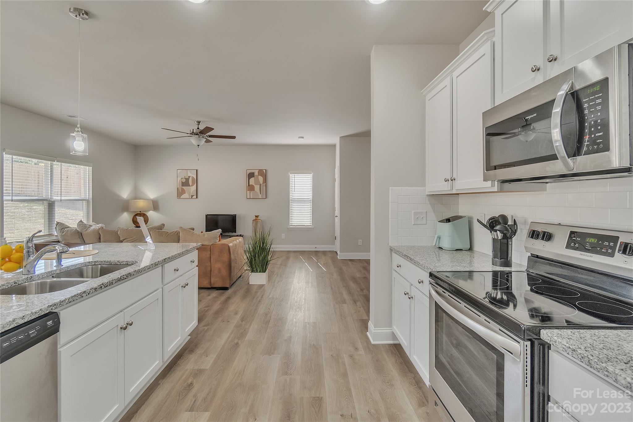 12840 Statesville Road, Unit 15B Huntersville, NC 28078 - Photo 15 of 37 a kitchen with a sink stove and microwave