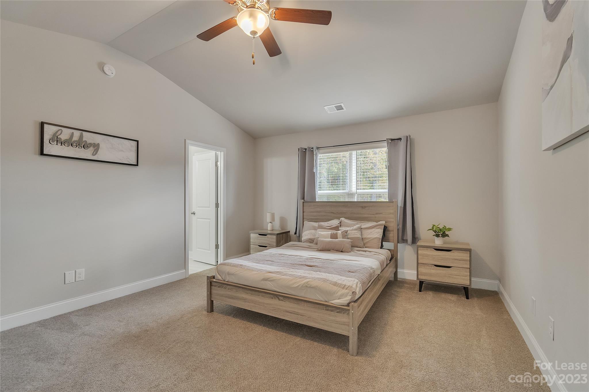 12840 Statesville Road, Unit 15B Huntersville, NC 28078 - Photo 18 of 37 a bedroom with a bed and a chandelier