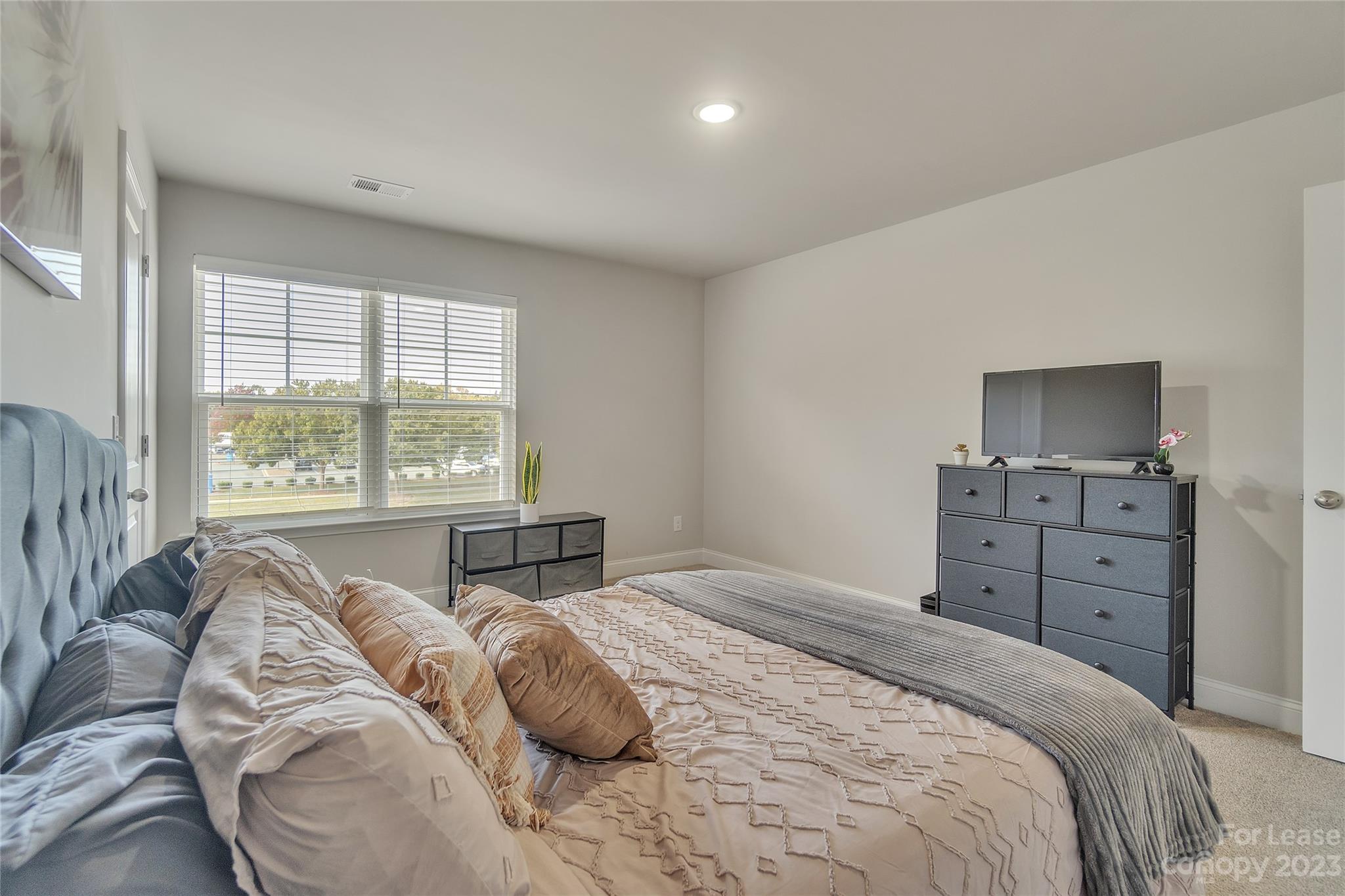 12840 Statesville Road, Unit 15B Huntersville, NC 28078 - Photo 23 of 37 a bedroom with a bed and wooden floor
