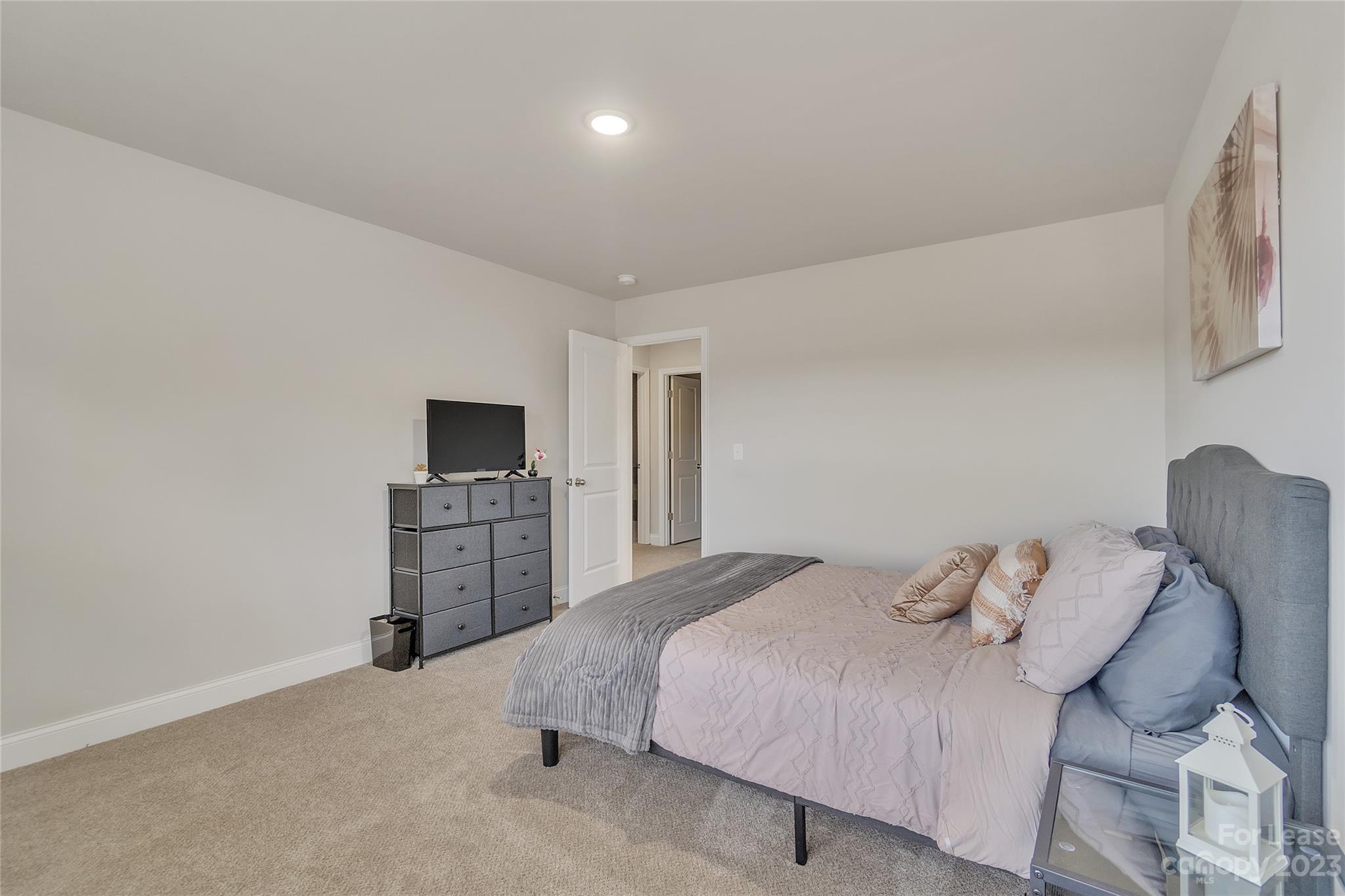 12840 Statesville Road, Unit 15B Huntersville, NC 28078 - Photo 25 of 37 a bedroom with a bed and a flat screen tv