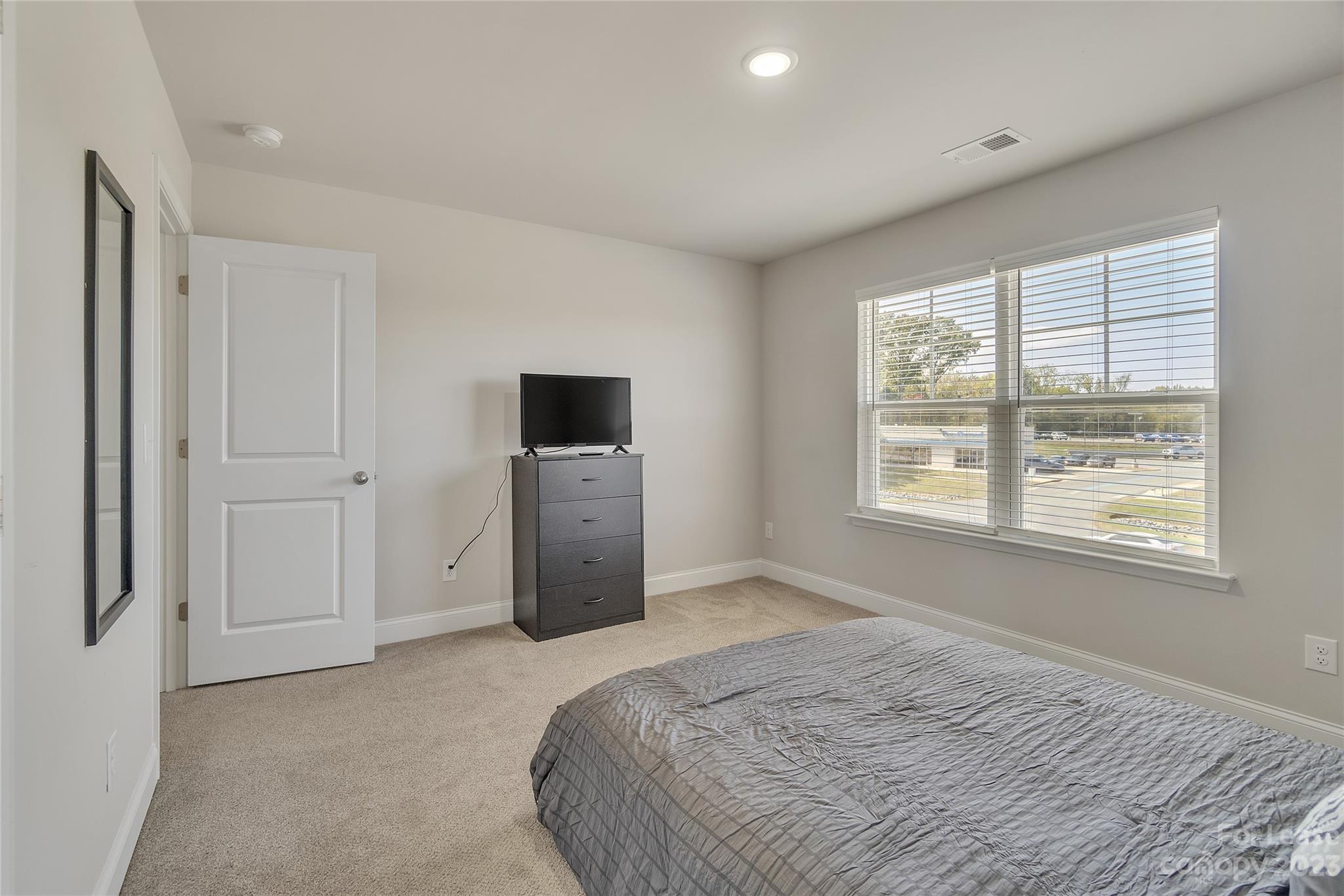 12840 Statesville Road, Unit 15B Huntersville, NC 28078 - Photo 29 of 37 a bed room with a bed and a television