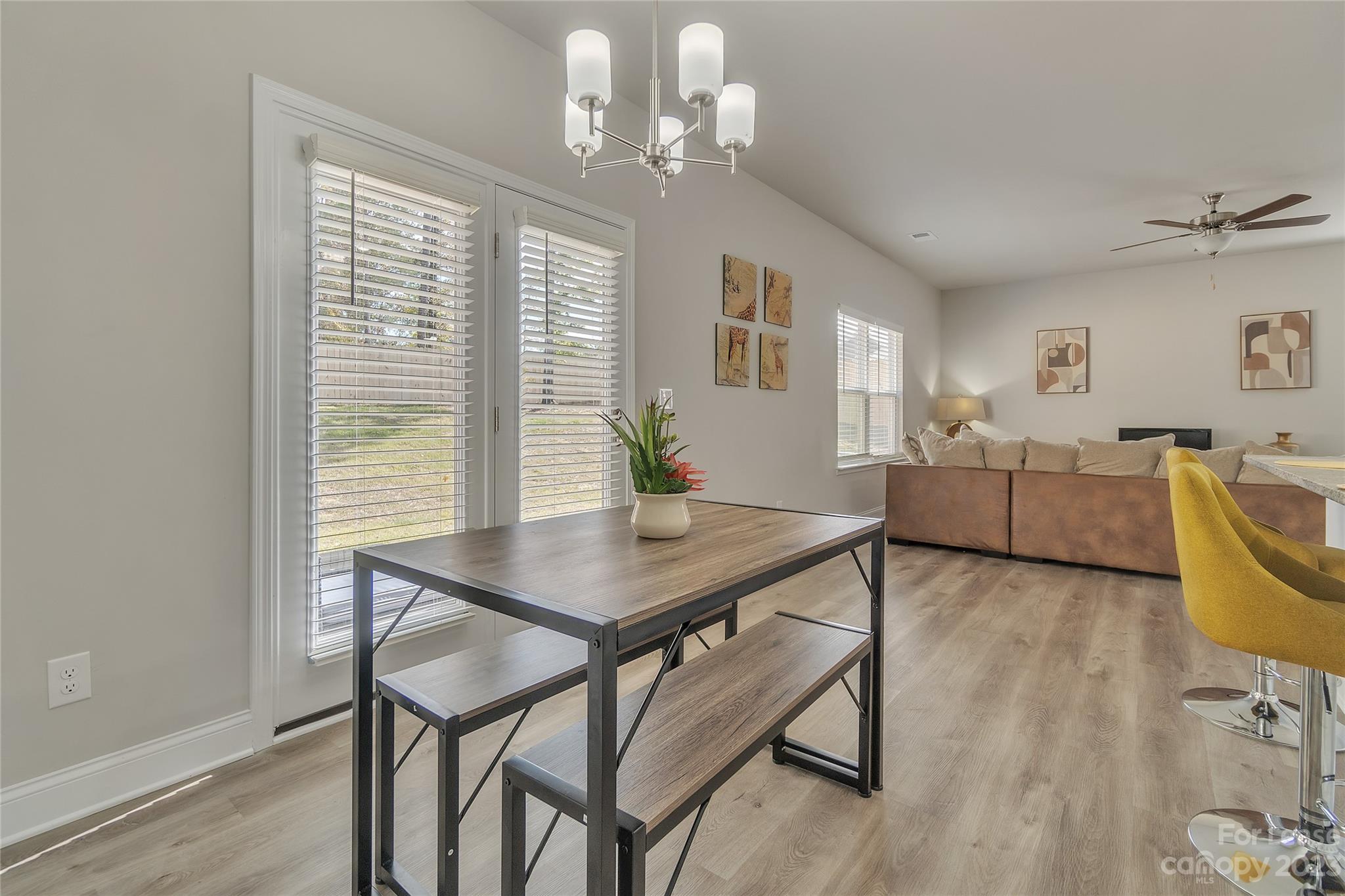 12840 Statesville Road, Unit 15B Huntersville, NC 28078 - Photo 10 of 37 a view of a dining room with furniture window and wooden floor