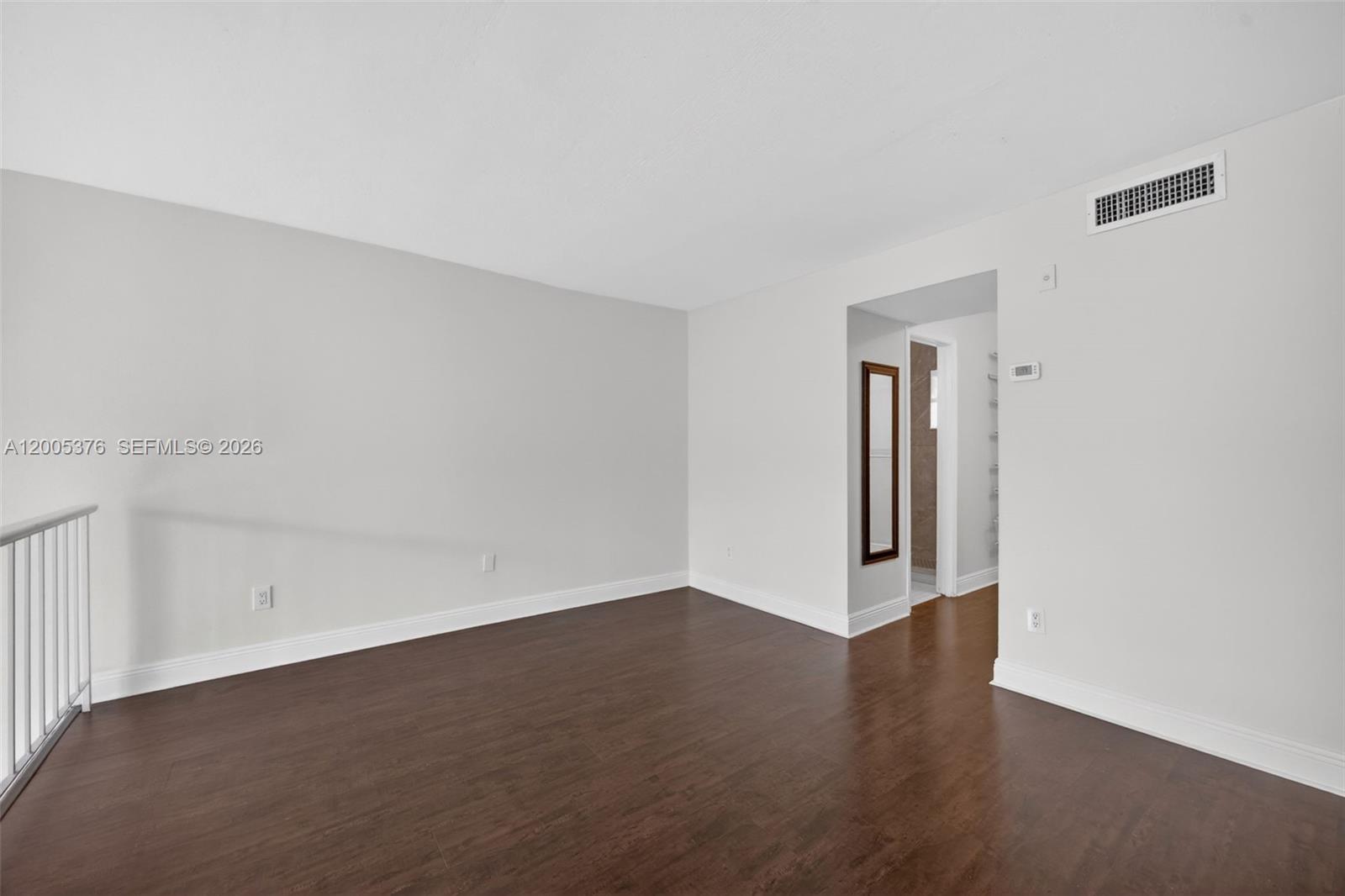 8550 Southwest 109th Avenue, Unit 5217 Miami, FL 33173 - Photo 15 of 34 a view of an empty room with wooden floor and a window