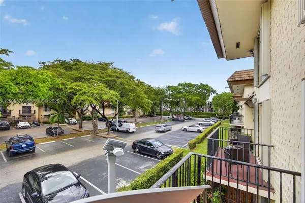 a view of a balcony with cars park