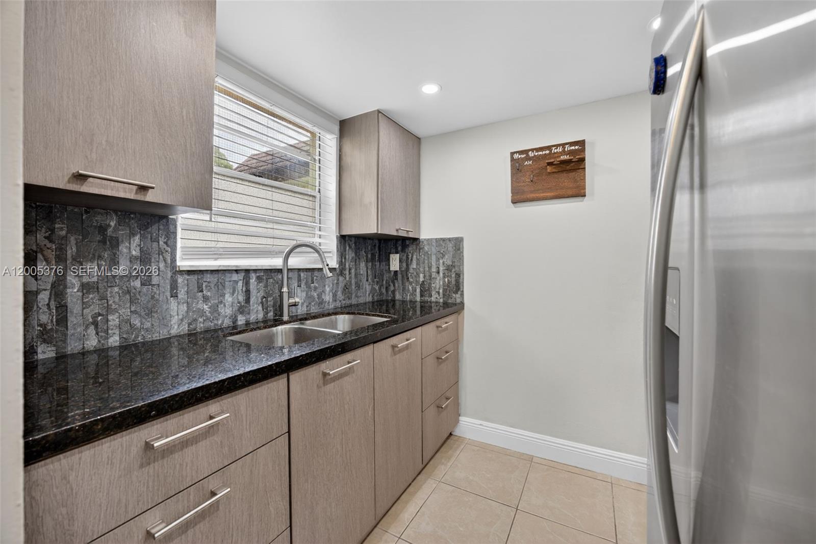 8550 Southwest 109th Avenue, Unit 5217 Miami, FL 33173 - Photo 4 of 34 a kitchen with stainless steel appliances granite countertop a sink and a refrigerator