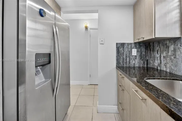 a kitchen with a refrigerator and cabinets