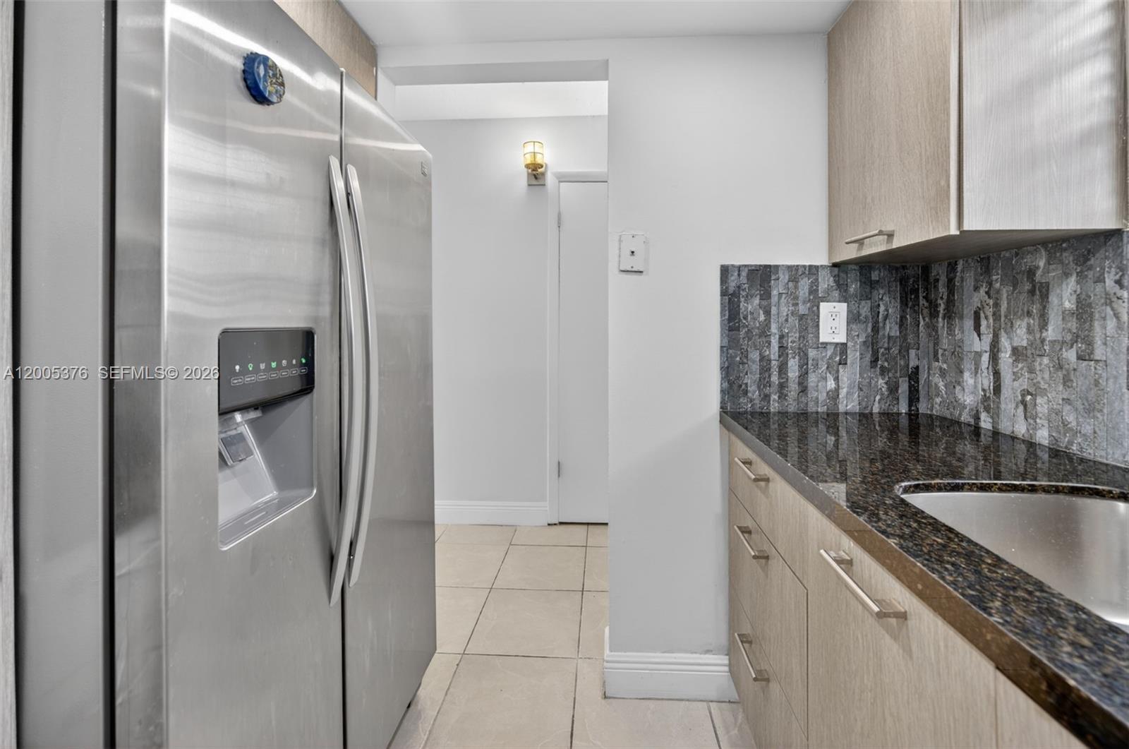 8550 Southwest 109th Avenue, Unit 5217 Miami, FL 33173 - Photo 7 of 34 a kitchen with a refrigerator and cabinets