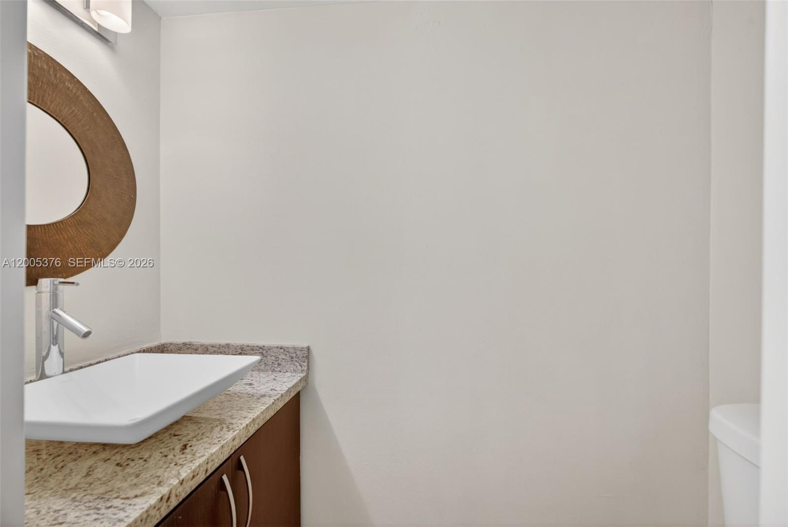 8550 Southwest 109th Avenue, Unit 5217 Miami, FL 33173 - Photo 9 of 34 a bathroom with a granite countertop sink and a mirror