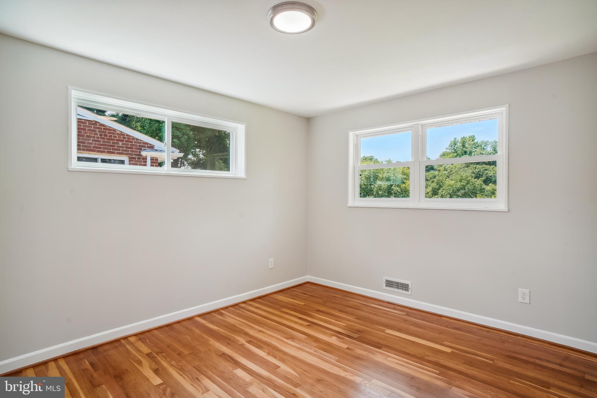 12924 Crisfield Road Silver Spring, MD 20906 - Photo 17 of 66 a view of an empty room with wooden floor and a window