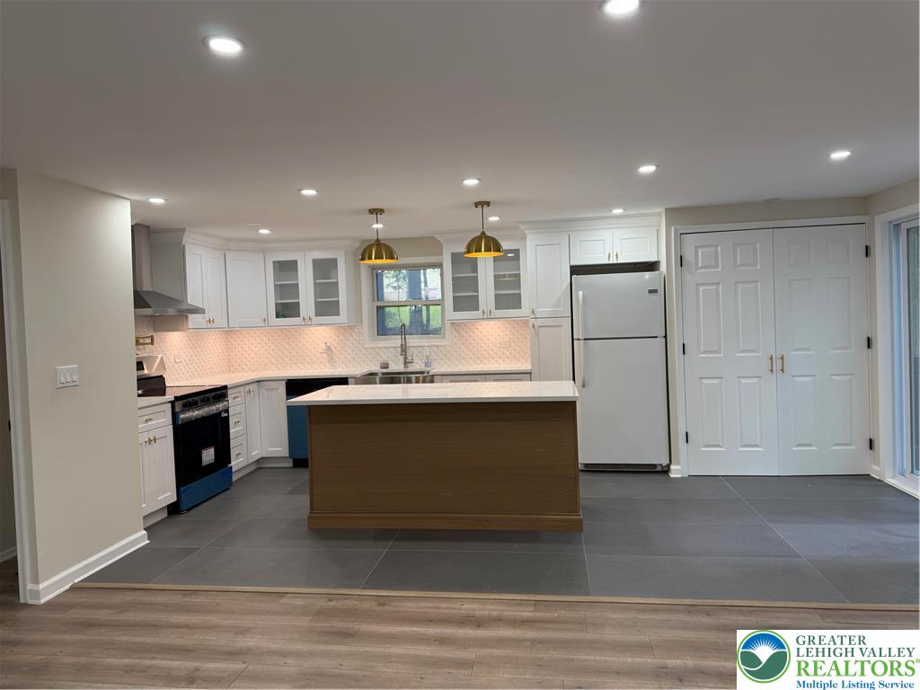 1405 Donalds Road Effort, PA 18330 - Photo 6 of 31 a large kitchen with stainless steel appliances kitchen island granite countertop a stove a sink and a refrigerator