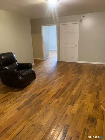 a living room with a couch and wooden floor