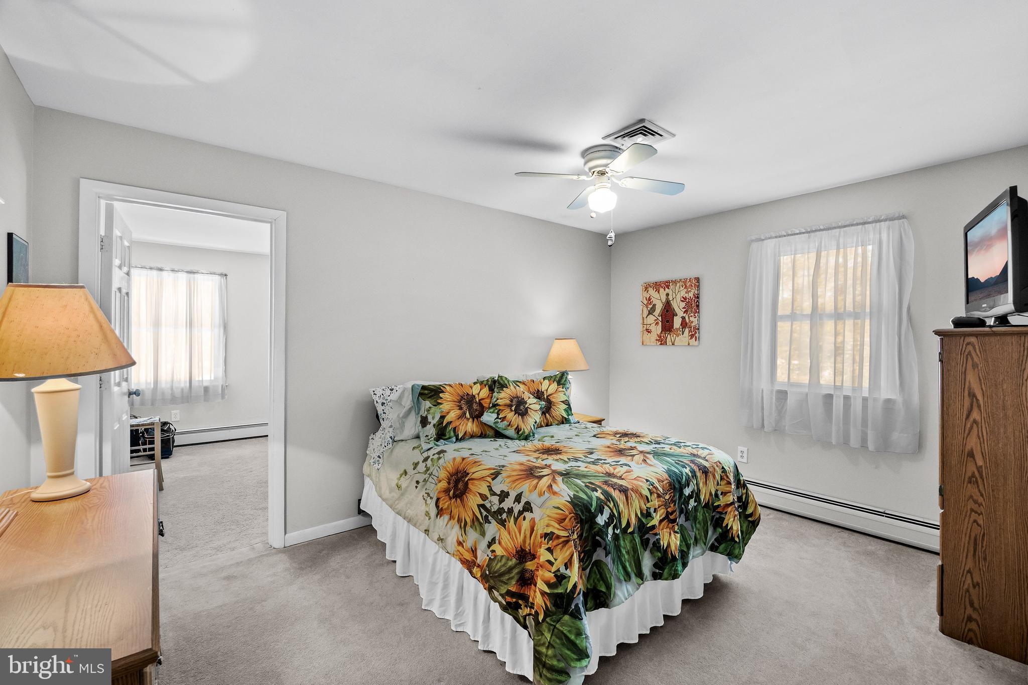 405 New Road Southampton, NJ 08088 - Photo 26 of 39 a bedroom with a bed and a chandelier