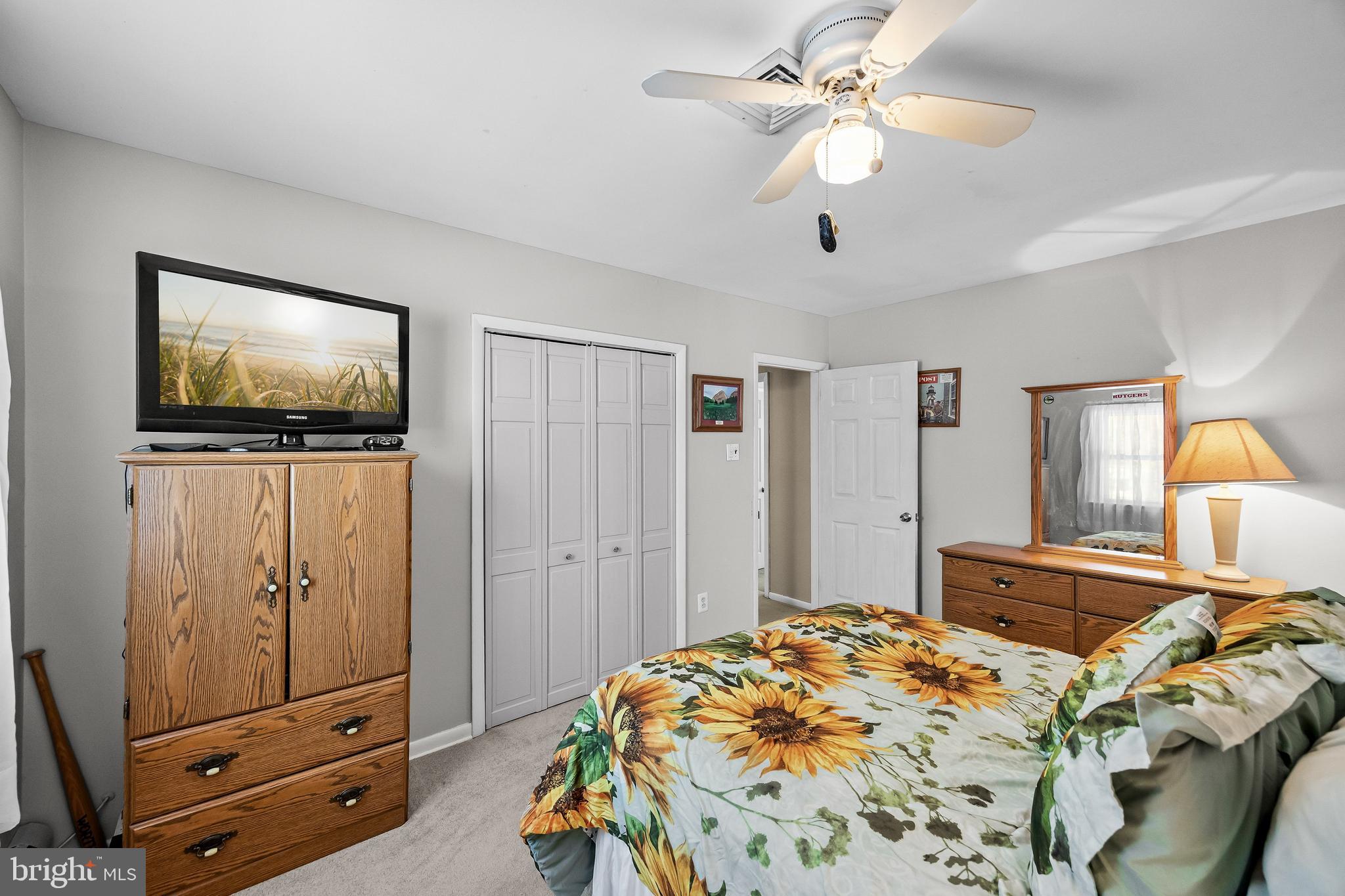 405 New Road Southampton, NJ 08088 - Photo 27 of 39 a bedroom with a bed and a flat tv screen on the dresser