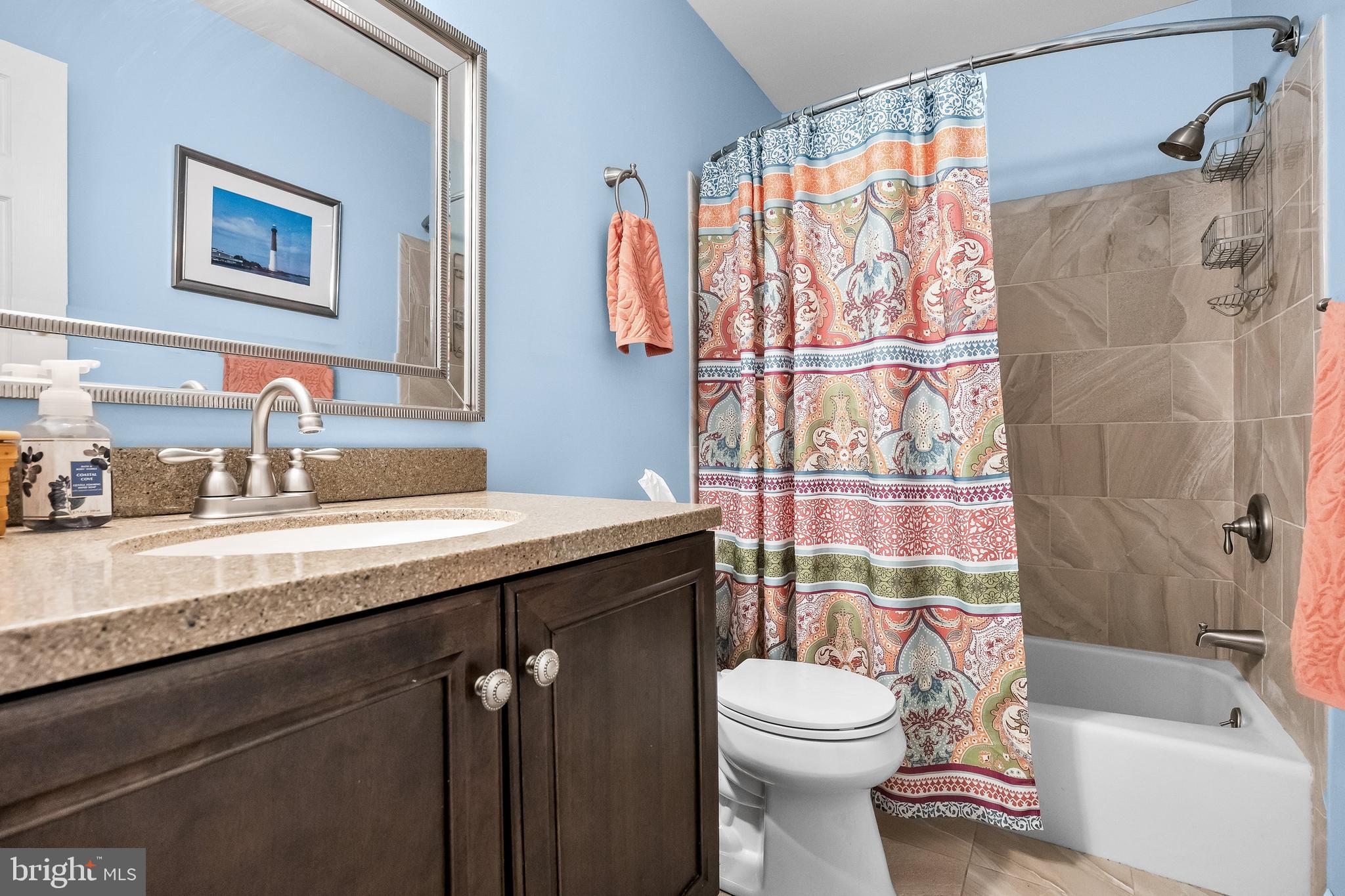 405 New Road Southampton, NJ 08088 - Photo 29 of 39 a bathroom with a sink a toilet and shower curtain