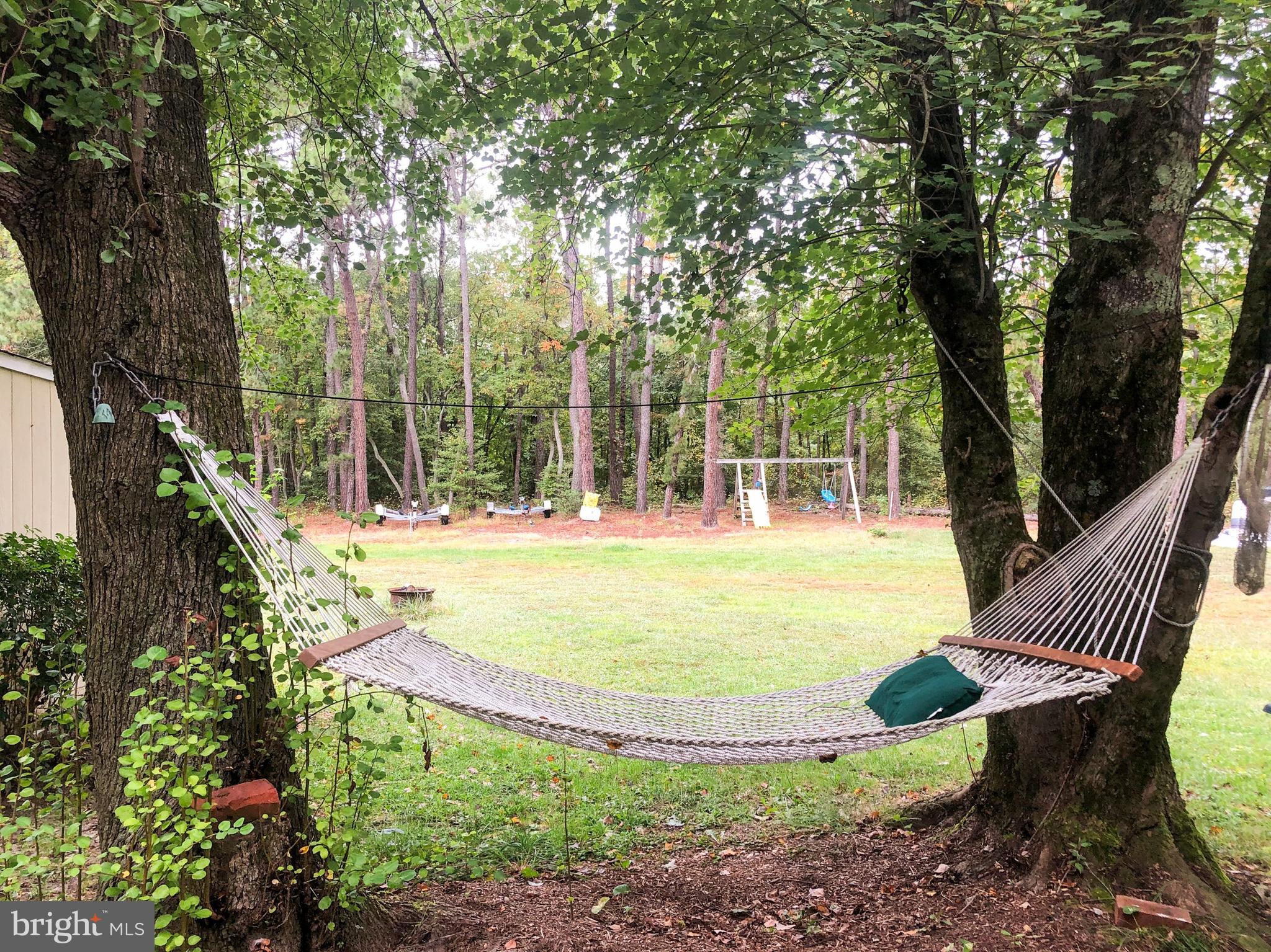 405 New Road Southampton, NJ 08088 - Photo 32 of 39 a view of a swimming pool with a sitting area and garden