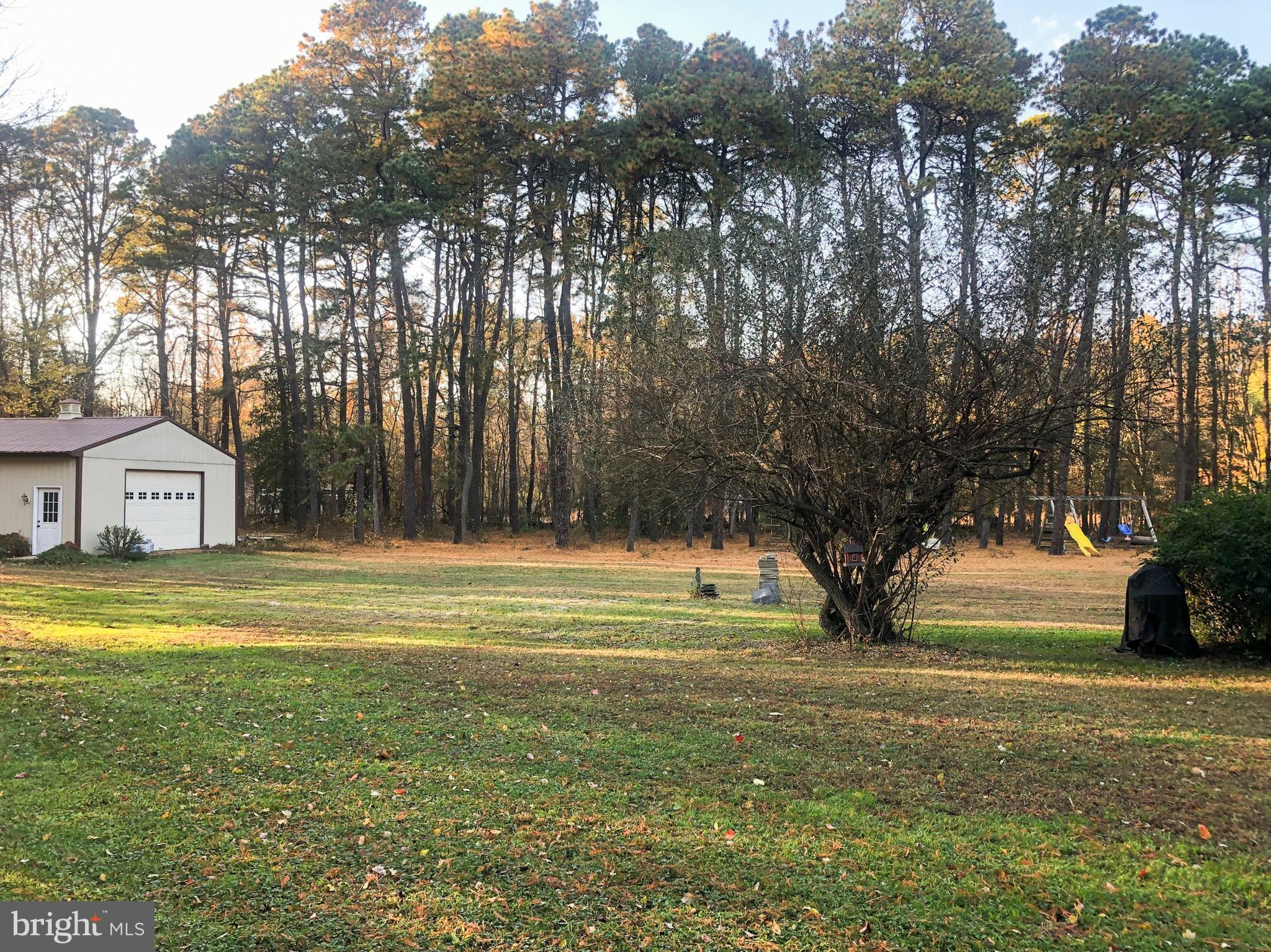 405 New Road Southampton, NJ 08088 - Photo 34 of 39 a view of swimming pool with a yard and large trees