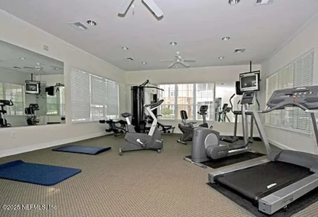 a room with gym equipment and a table