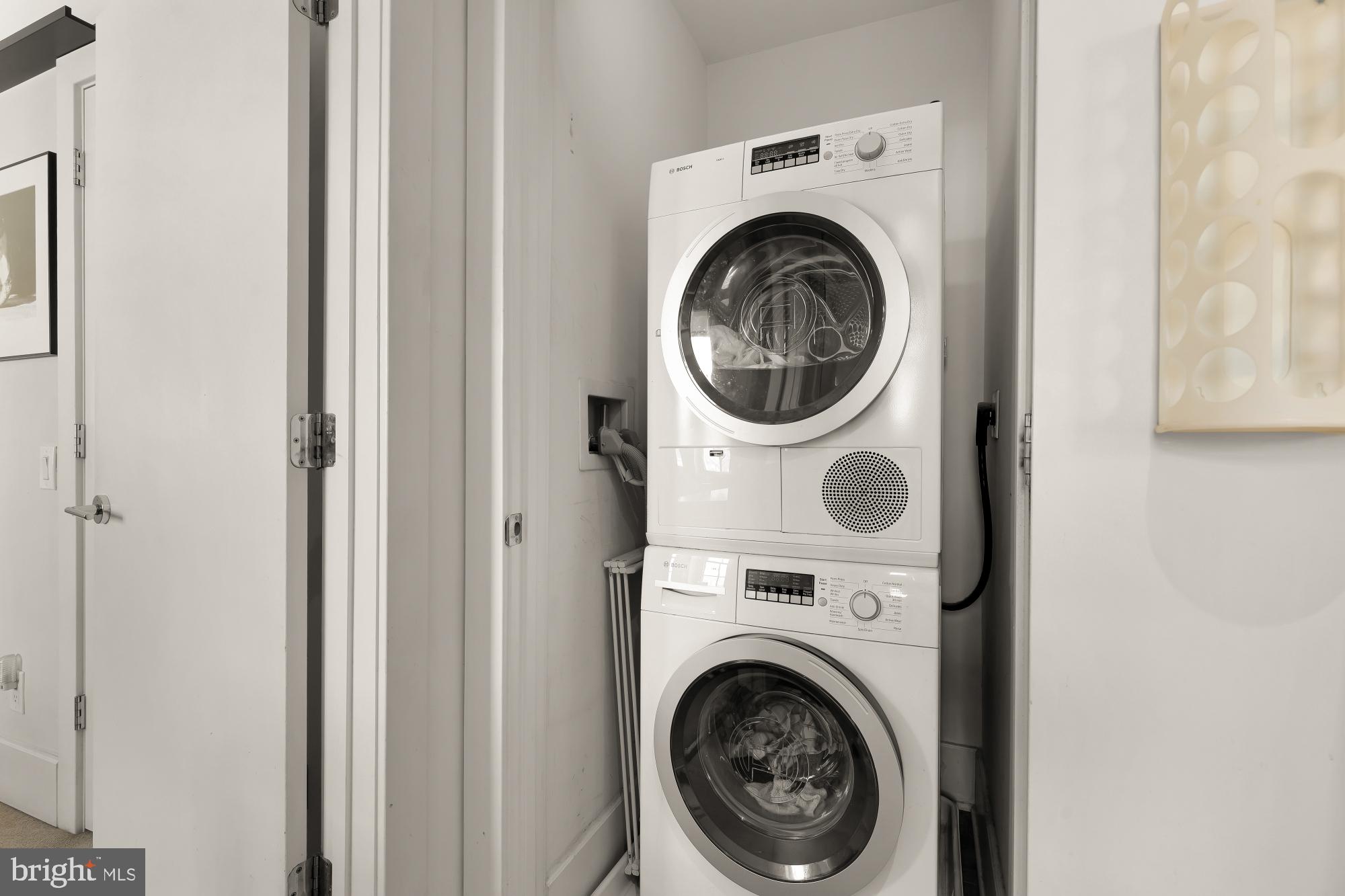 2926 Porter Street Northwest, Unit 306 Washington, DC 20008 - Photo 11 of 19 a view of a hallway with washer and dryer