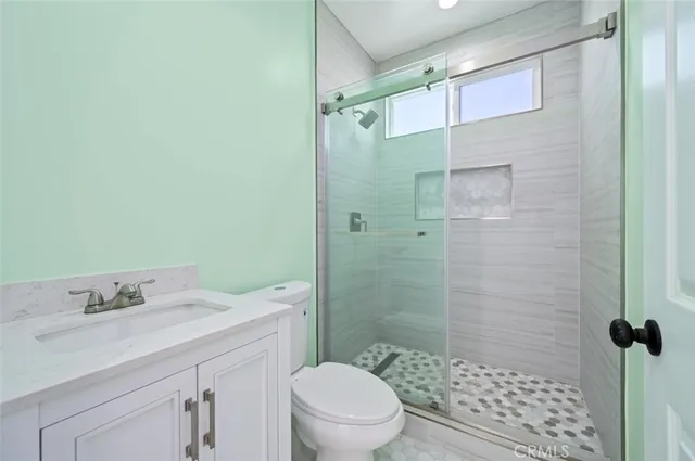 an empty room with closet and wooden floor