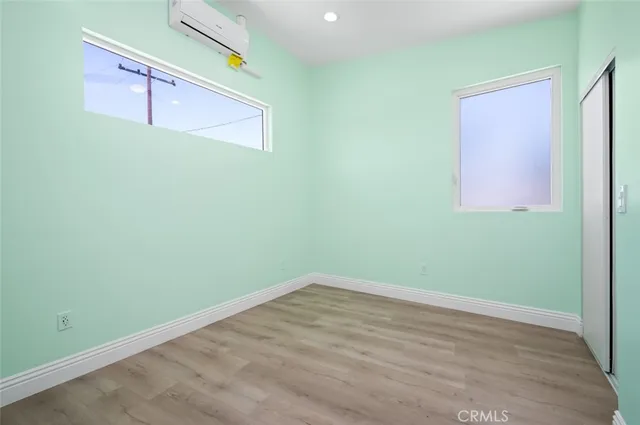 a view of a room with wooden floor and cabinet
