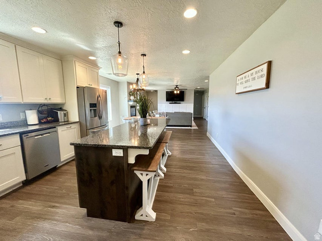 310 625 East Enterprise, UT 84725 - Photo 9 of 36 Kitchen with white cabinetry, granite countertops, and stainless steel appliances