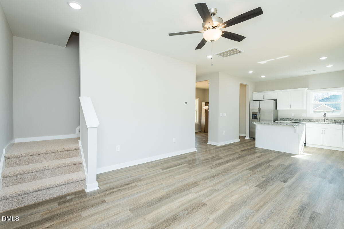 2823 Ricolden Trail Elon, NC 27244 - Photo 12 of 26 a view of a kitchen with wooden floor and a ceiling fan