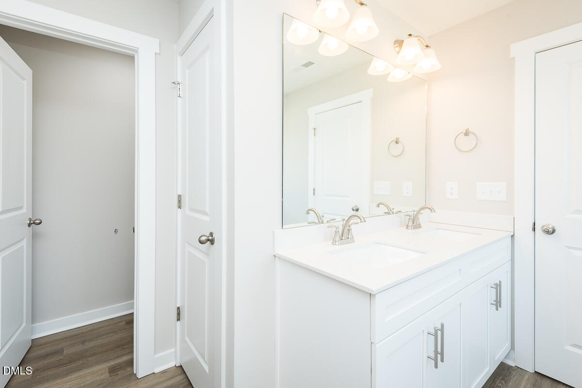 2823 Ricolden Trail Elon, NC 27244 - Photo 26 of 26 a bathroom with a sink vanity and mirror