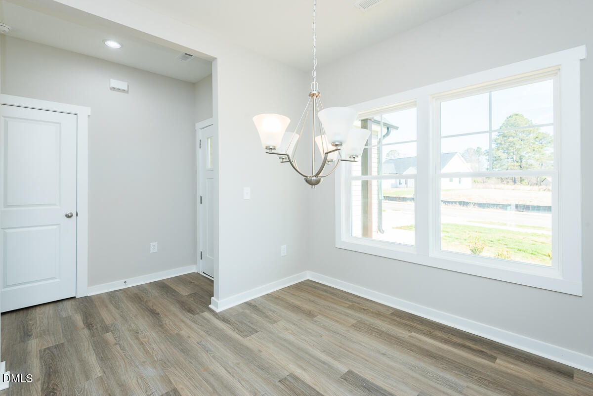 2823 Ricolden Trail Elon, NC 27244 - Photo 5 of 26 a view of empty room with wooden floor and fan