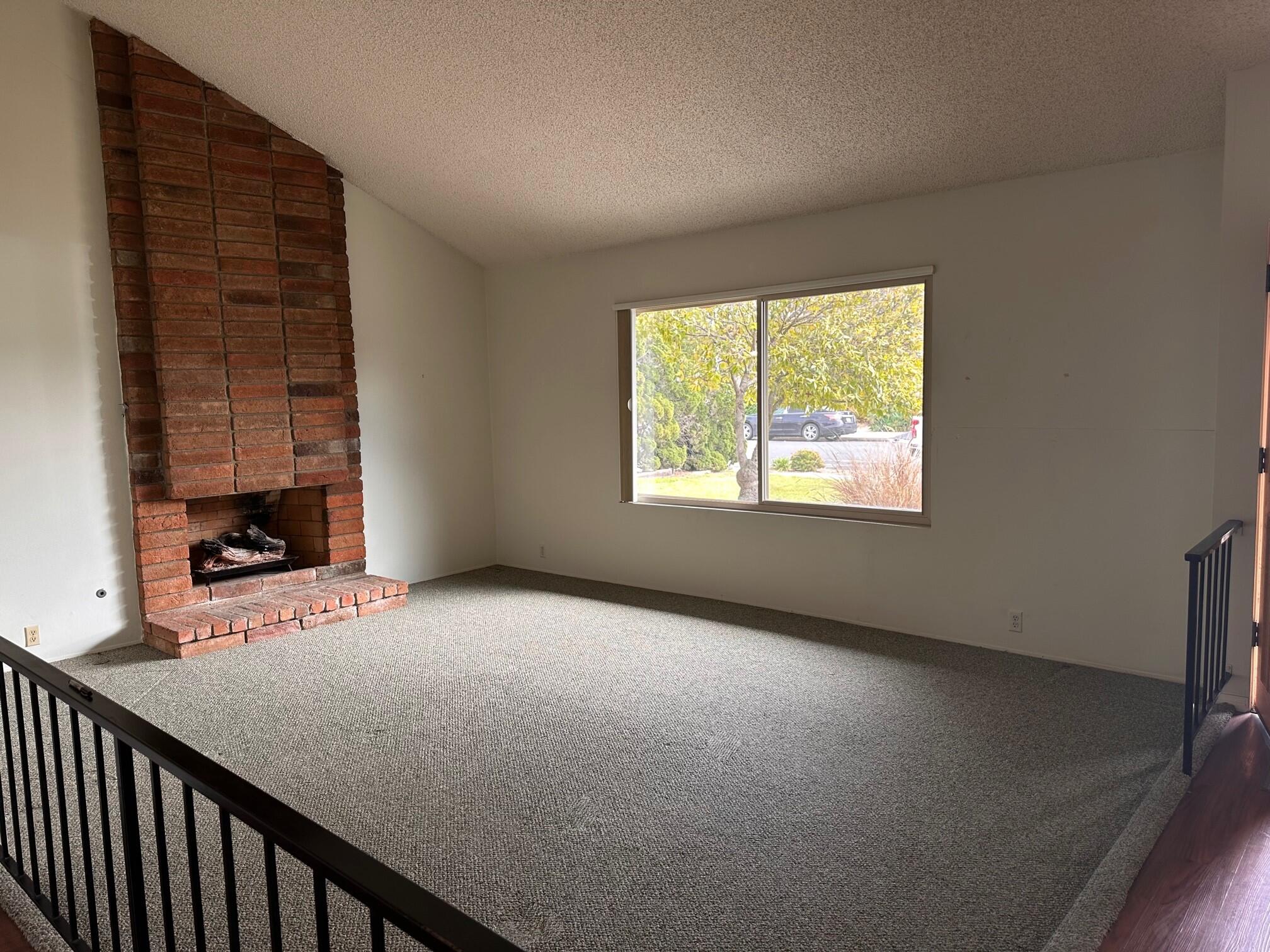7248 Georgetown Road Goleta, CA 93117 - Photo 4 of 9 a view of an empty room with a fireplace and a window